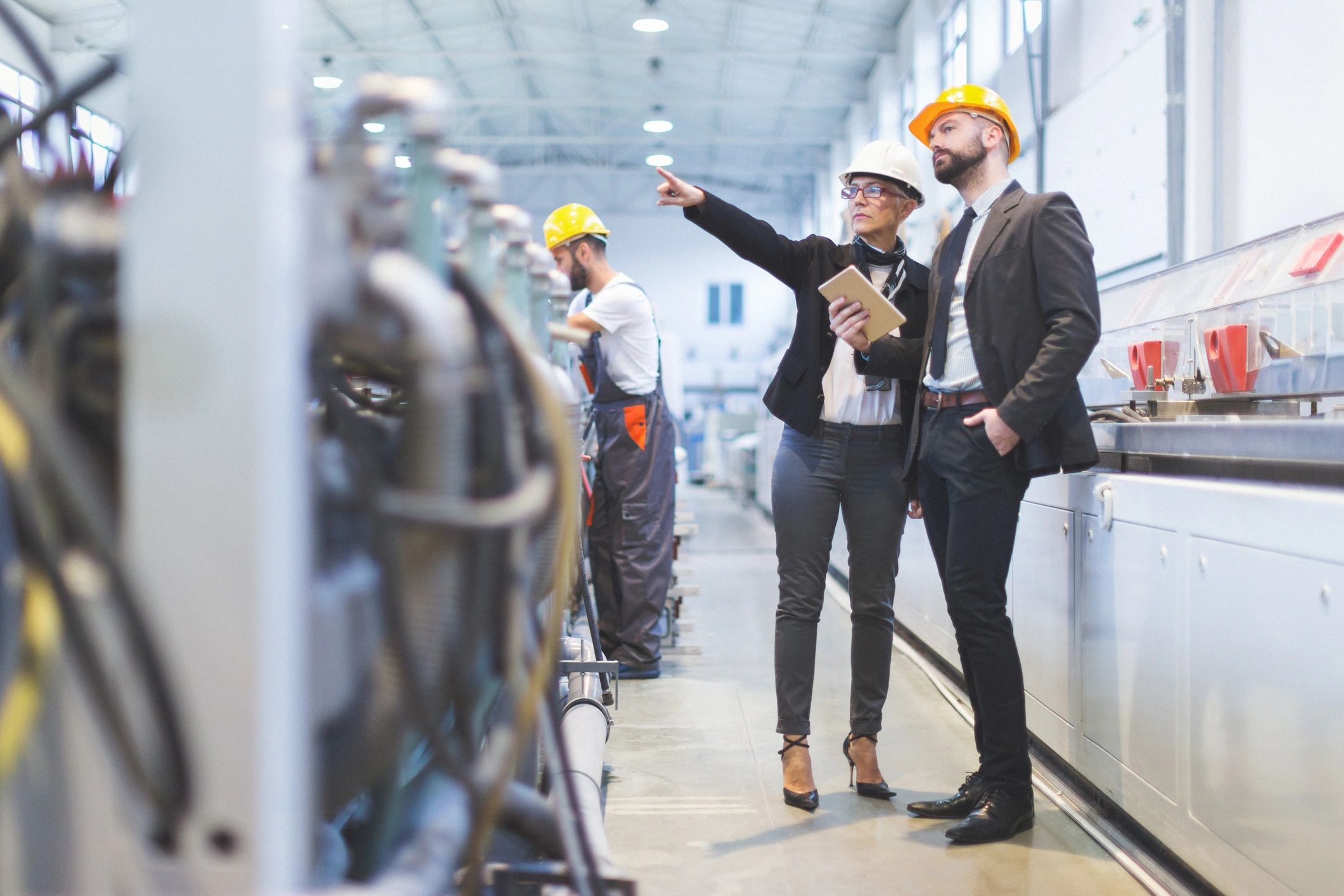 Construction professionals reviewing industrial equipment