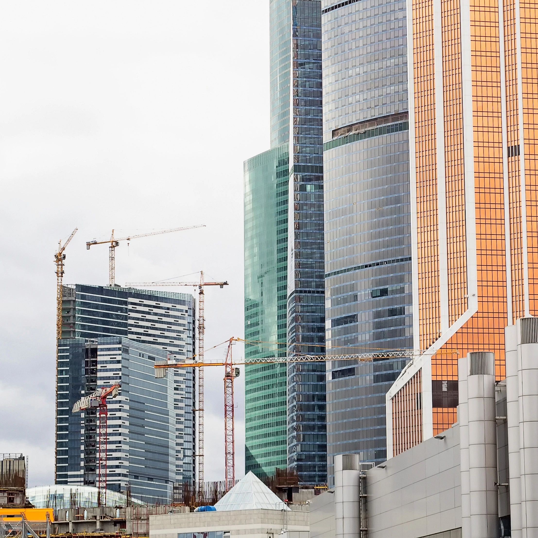 Urban construction skyline with active cranes